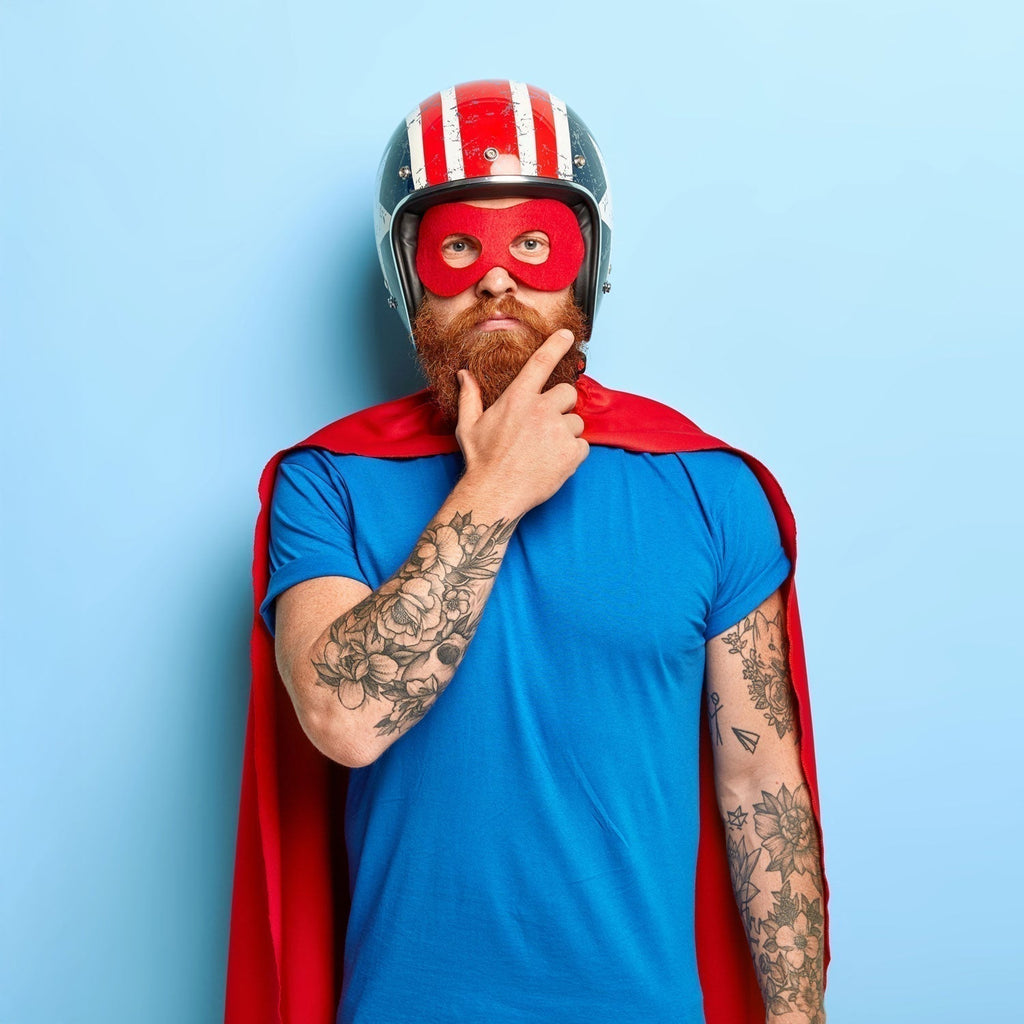 a man dressed in a home made superhero outfit as an cover image for an article listing some of the best superhero-themed board games